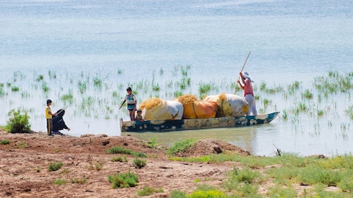 Local people cross the flooded Hawizeh Marshes, near the Majnoon project in Iraq