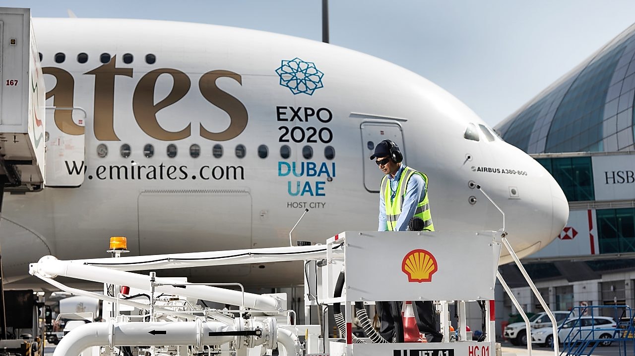 a man standing on a platform next to a large airplane