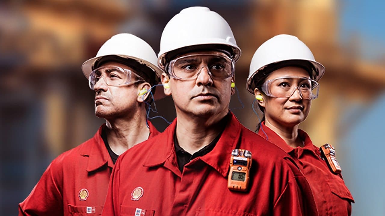 a group of people wearing hardhats and red shirts