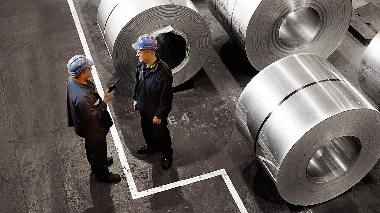 two workers in a metal factory