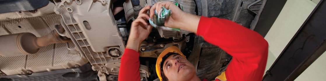 employee doing fitting of parts in car