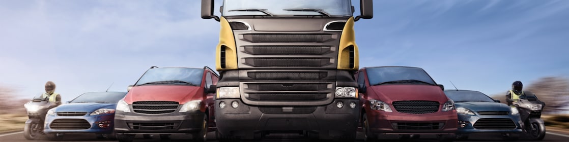 Motorcycles, cars and trucks on road