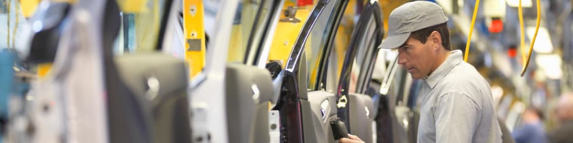 man holding wire looking at machine