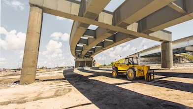 a digger truck at a road flyover construction site