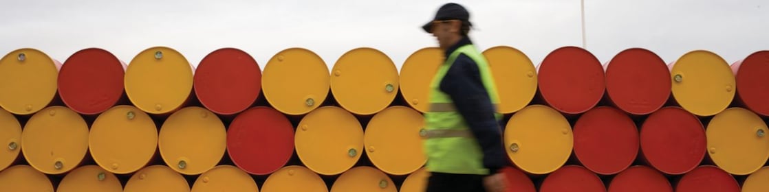 man walking barrels lubricants