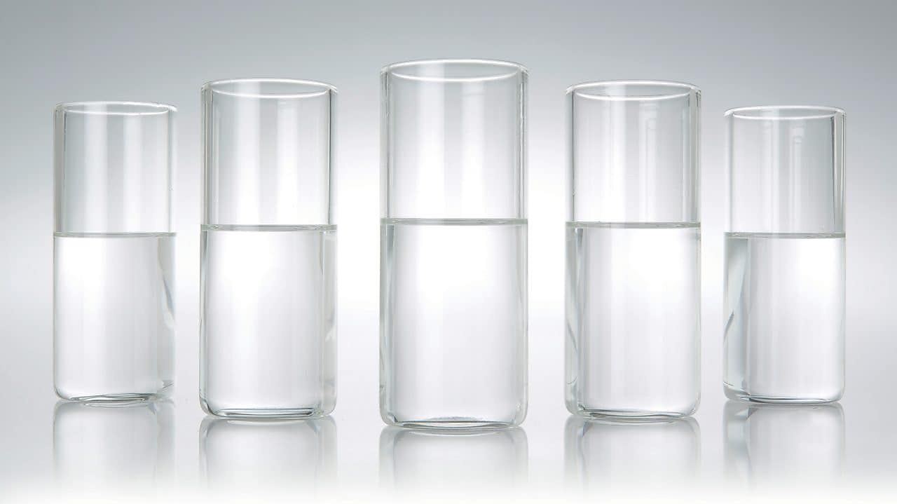 Five beakers in a row with a clear liquid in each one