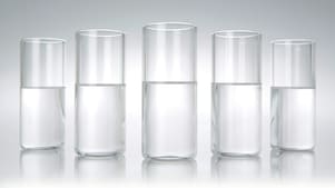 Five beakers in a row with a clear liquid in each one