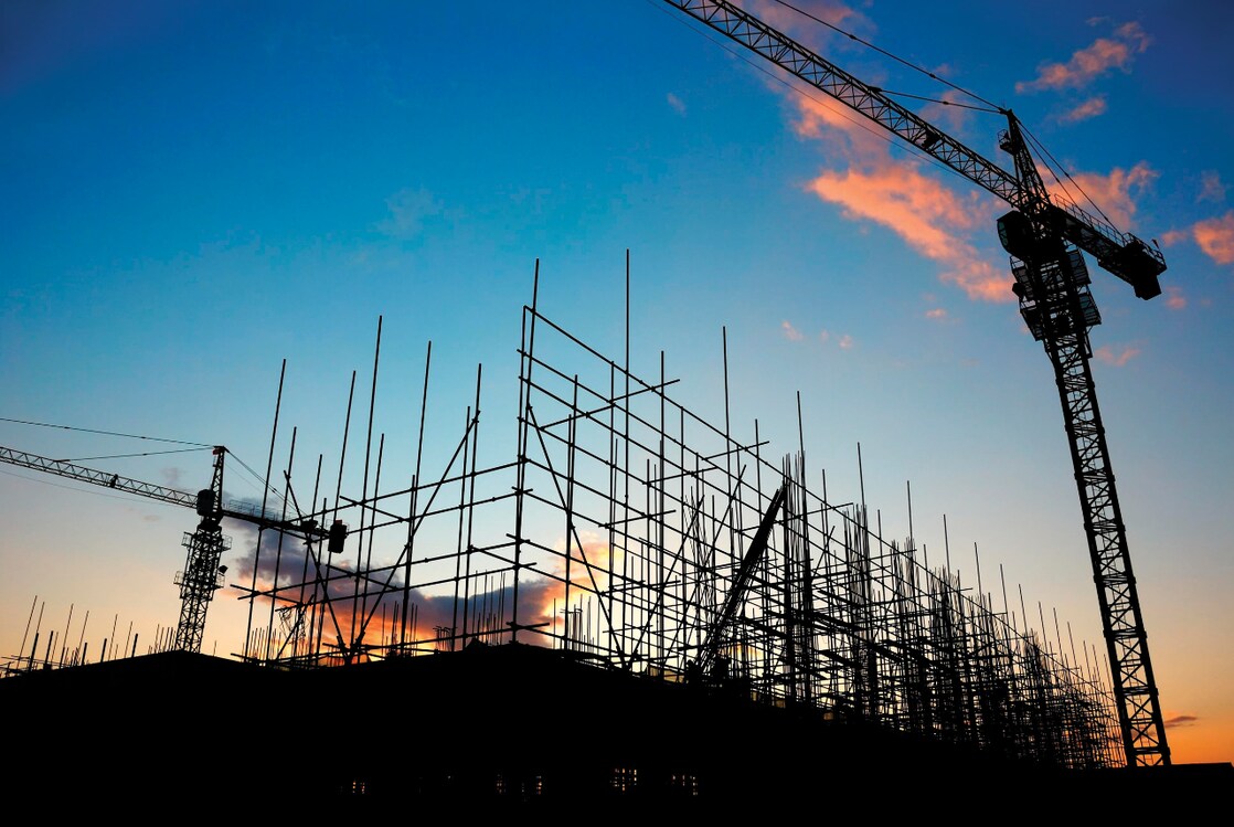 Cranes at construction site late evening
