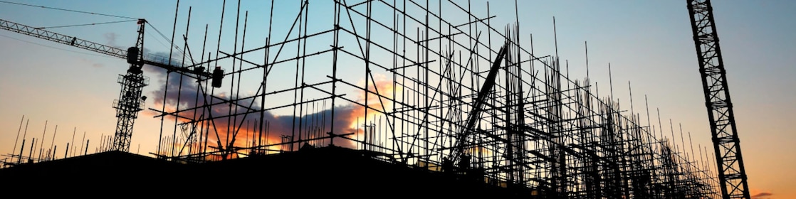 Cranes at construction site late evening