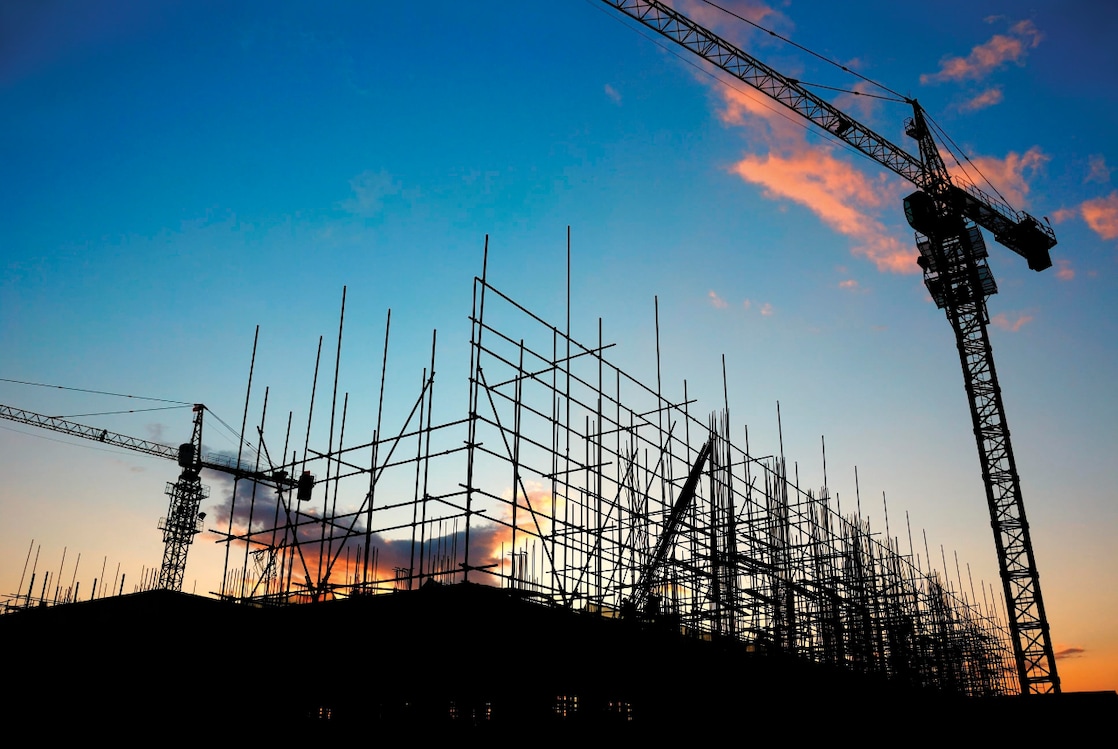 Cranes at construction site late evening