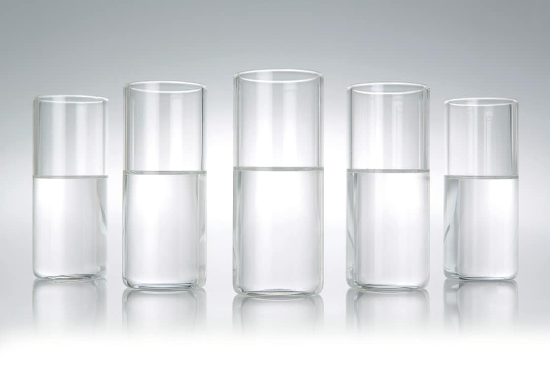 Five beakers in a row with a clear liquid in each one