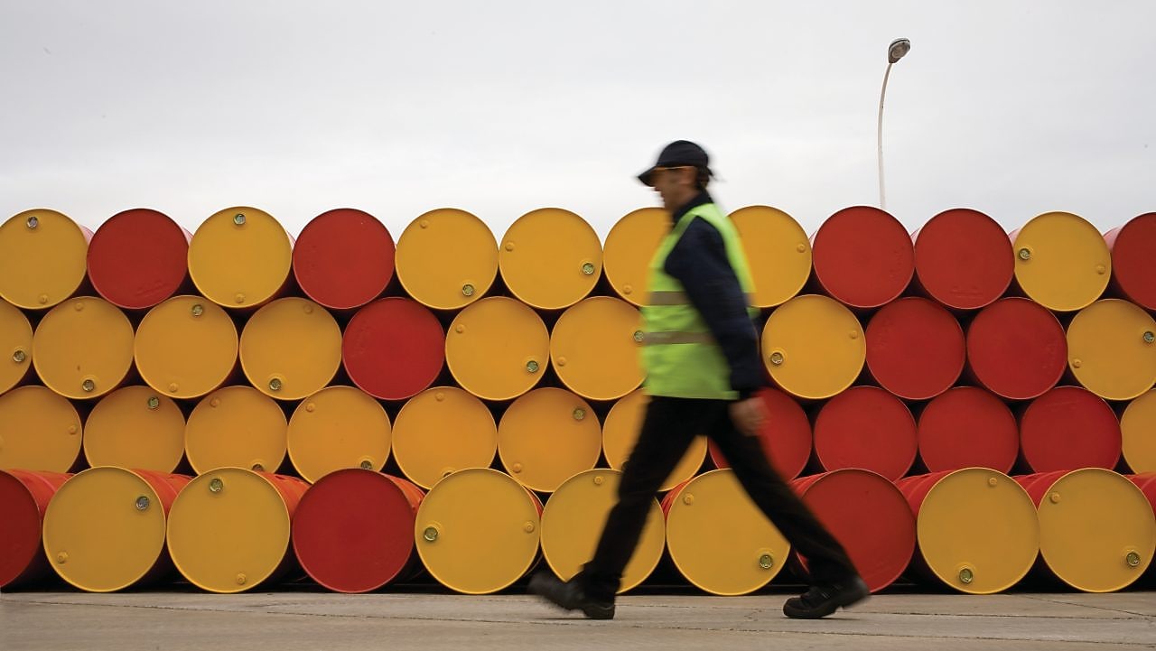 Man walking barrels lubricants