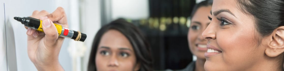 Business leader writing on whiteboard