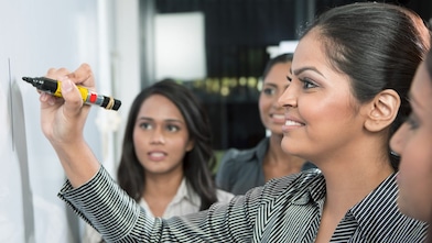 Business leader writing on whiteboard