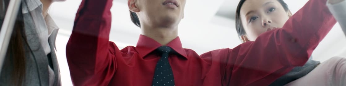 man showing bluprint to colleagues