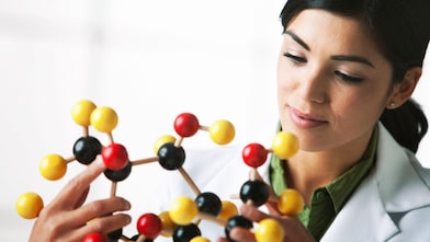 scientist looking at molecule model
