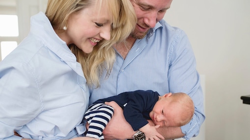 Claire P and her husband Robin, holding their son James