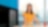 A female Shell employee in the office happily gazing afar