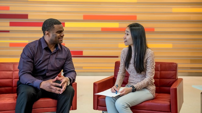 two individuals discussing