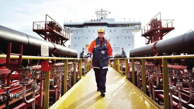 worker walking around a Shell vessel