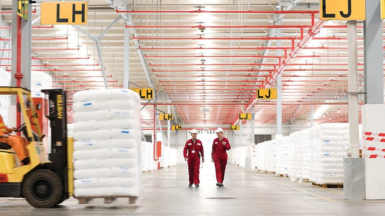 two employees walking in a factory