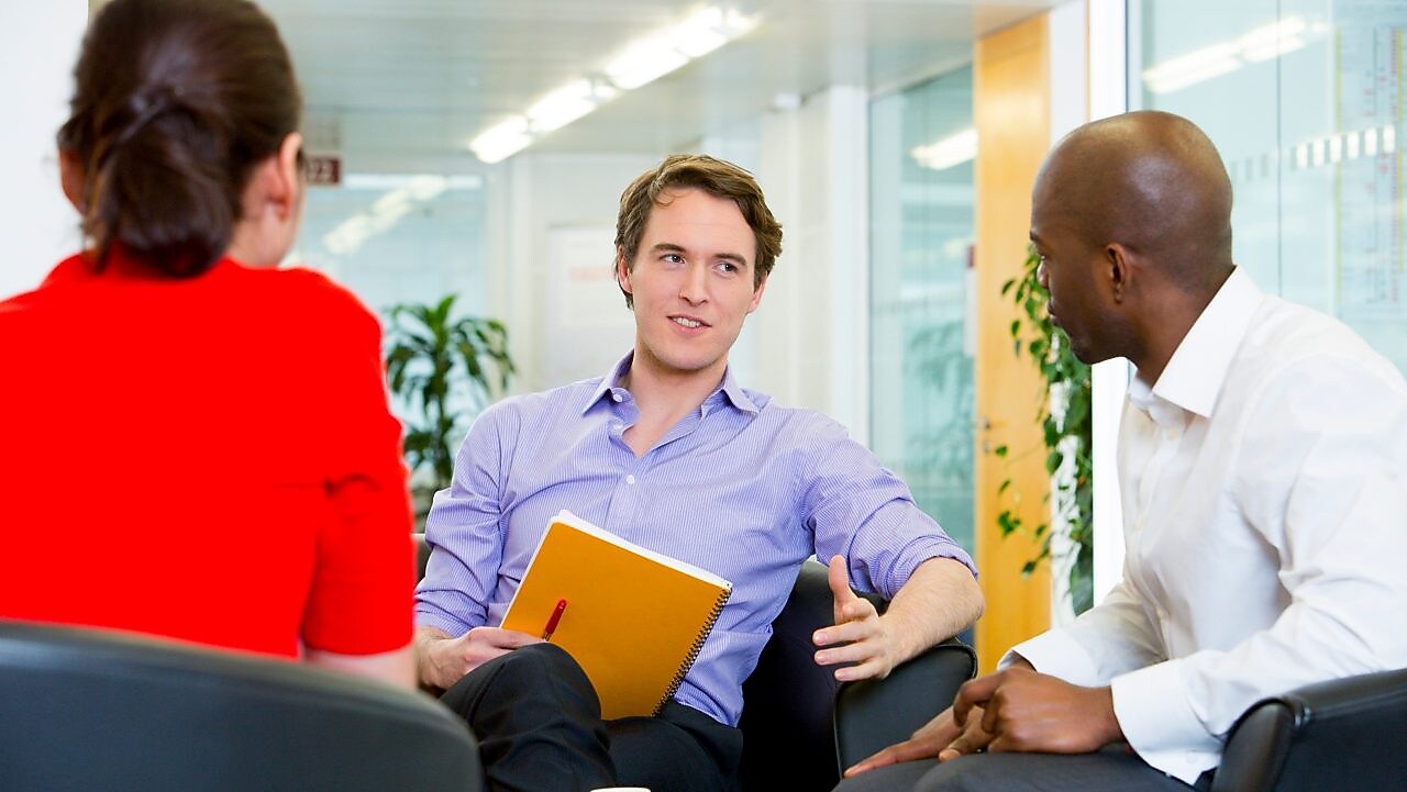 two employees interviewing a potential candidate