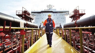 worker walking around a Shell vessel