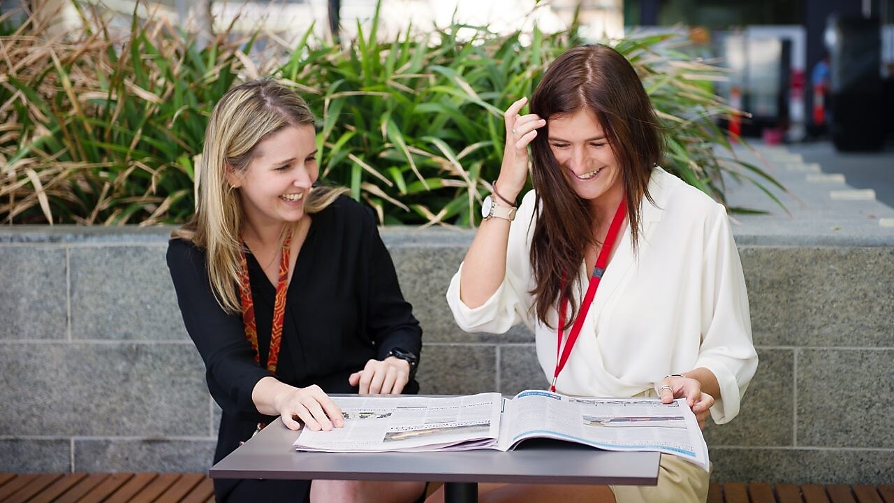 Two women discussing and laughing
