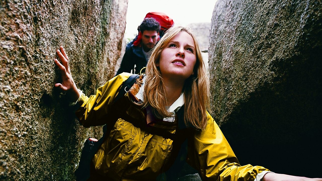 Two People Orienteering Between Rocks