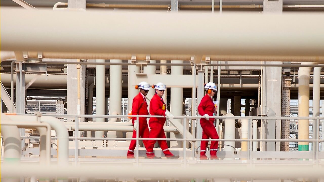 Shell workers walking across the pipe track