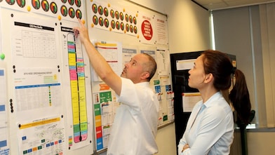 Shell mentor Scott Low with graduate Inah Felisse Margaja pointing to a diagram on the notice board