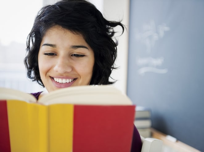 Hispanic woman reading a book