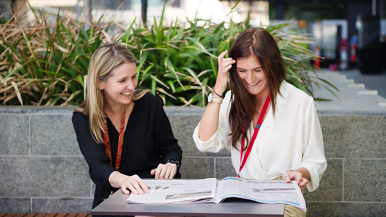 Two women discussing and laughing
