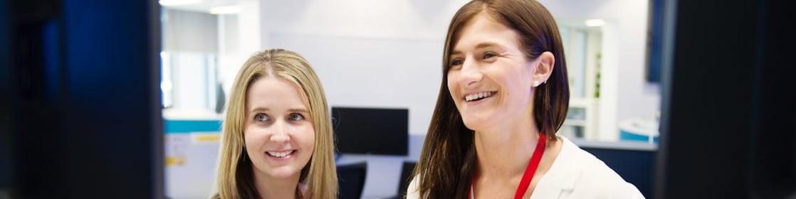 From right - Shell Graduate Samantha Palmer with her mentor Elise-Anne Muir standing in front of a computer screen