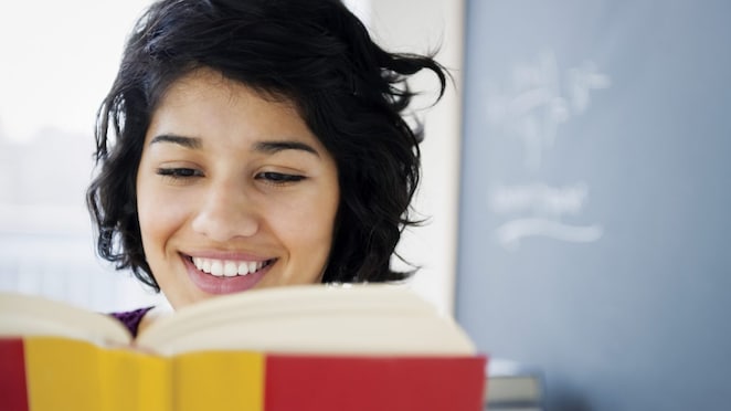 Hispanic woman reading a book