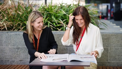 Two women discussing and laughing