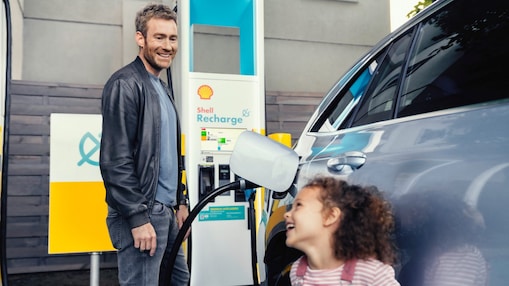 Man filling up electric vehicle with Shell Recharge