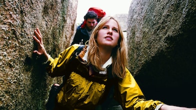 Two People Orienteering Between Rocks