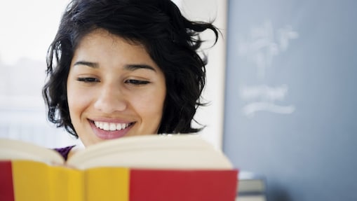 Hispanic woman reading a book