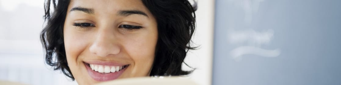 Hispanic woman reading a book