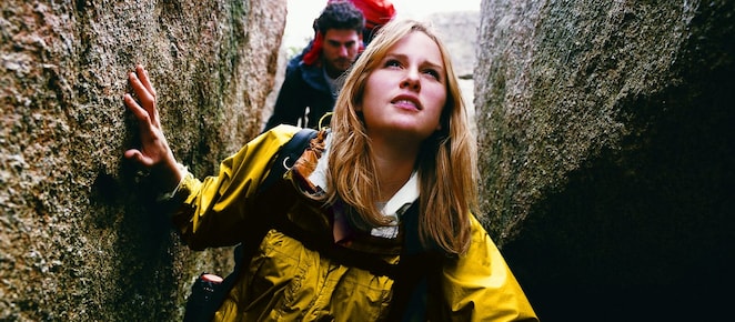 Two People Orienteering Between Rocks