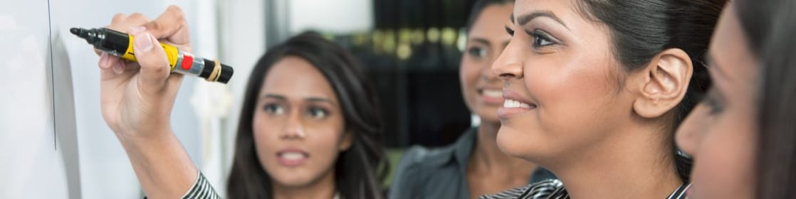 Business leader writing on whiteboard