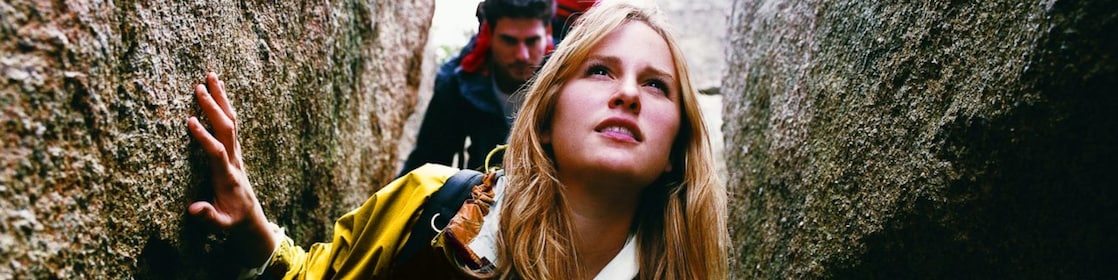 Two People Orienteering Between Rocks