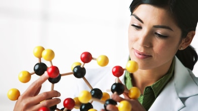 scientist looking at molecule model