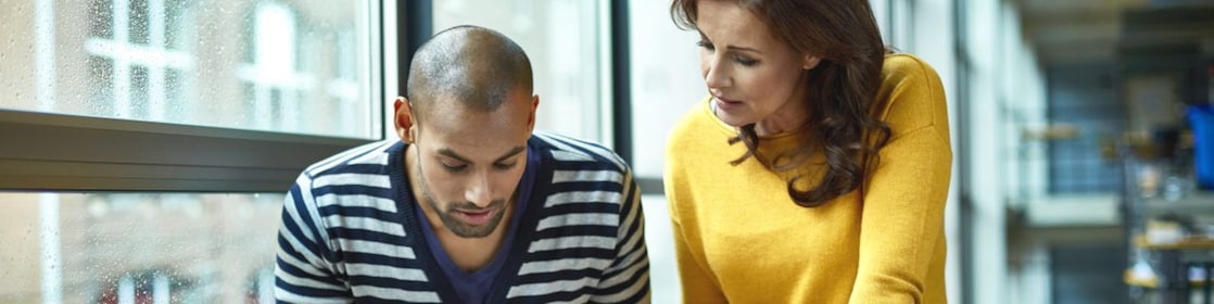 Two architects discussing project at high table