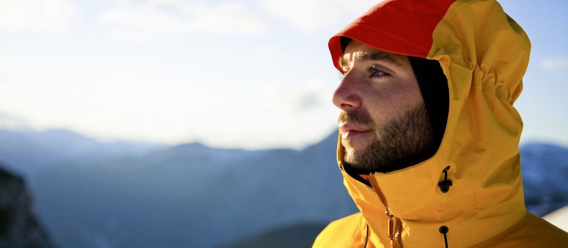 Aerial view of man working in safety gear climbing scaffolding