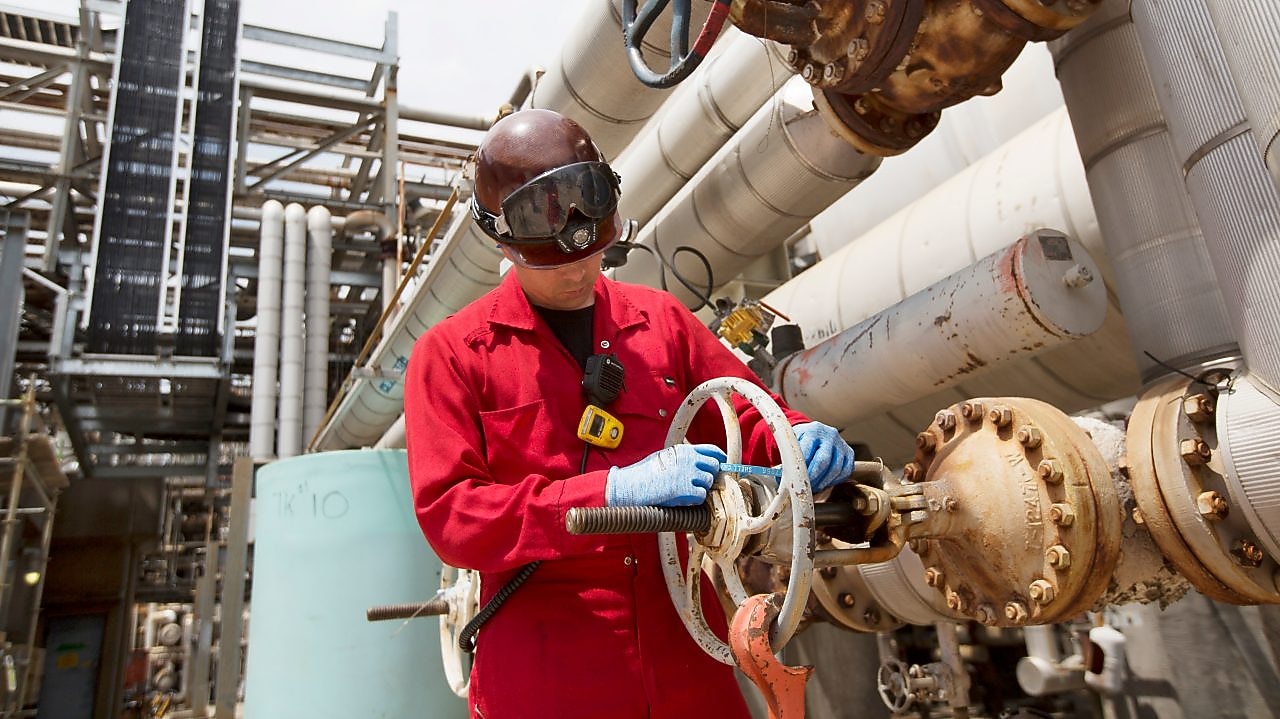 An engineer checks platform equipment for safety