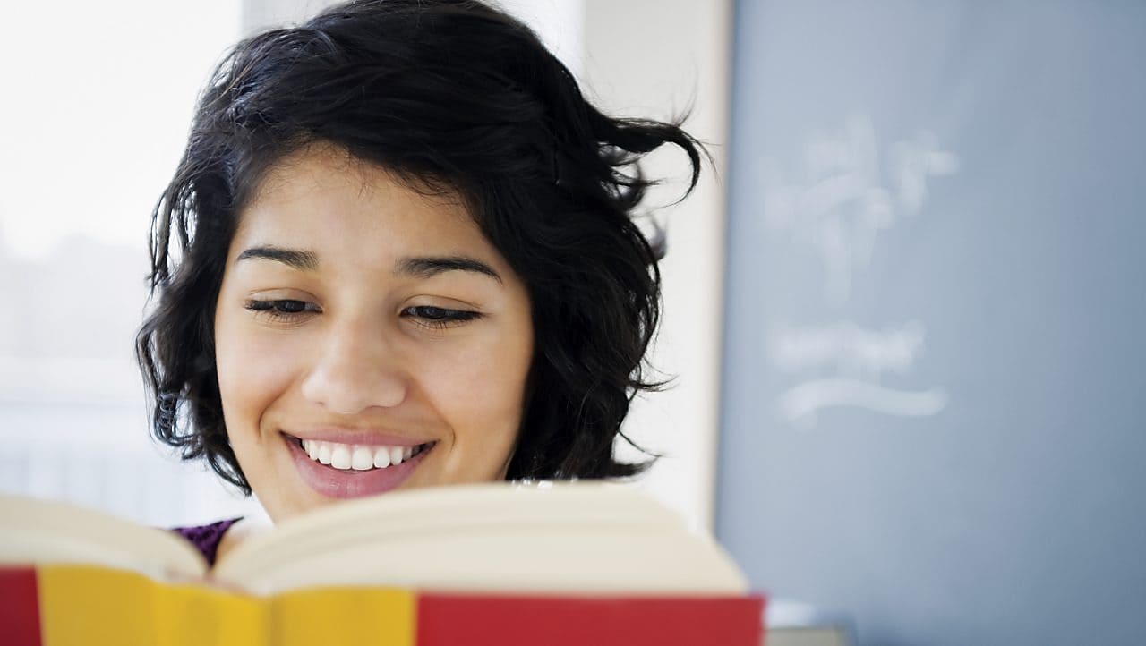 Hispanic woman reading a book