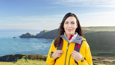 Woman standing in the mountain with bags
