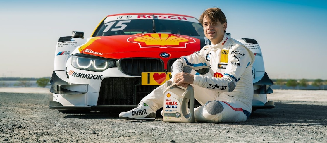 red bmw car with racer